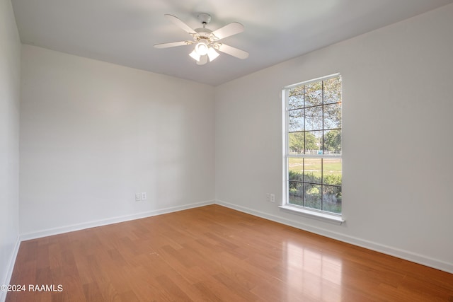 empty room with ceiling fan and wood-type flooring