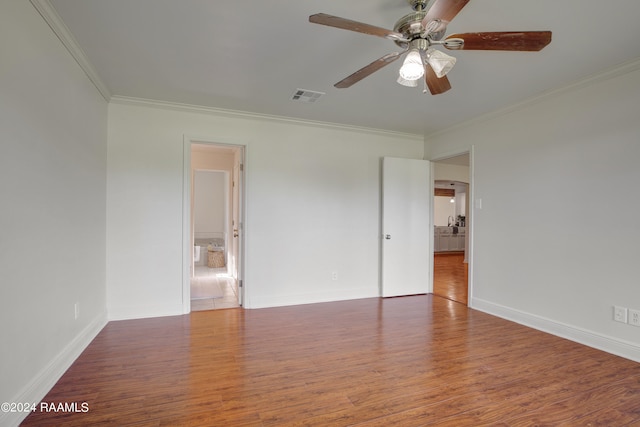 unfurnished bedroom featuring ornamental molding, dark hardwood / wood-style floors, and ceiling fan