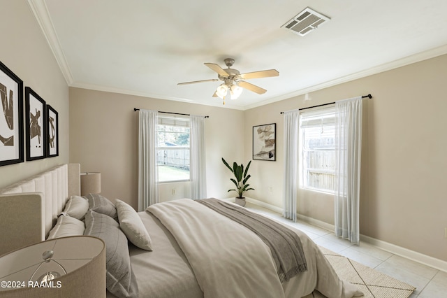 bedroom featuring ceiling fan, light tile patterned floors, and ornamental molding