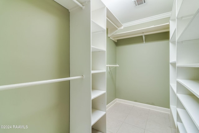 spacious closet with light tile patterned floors