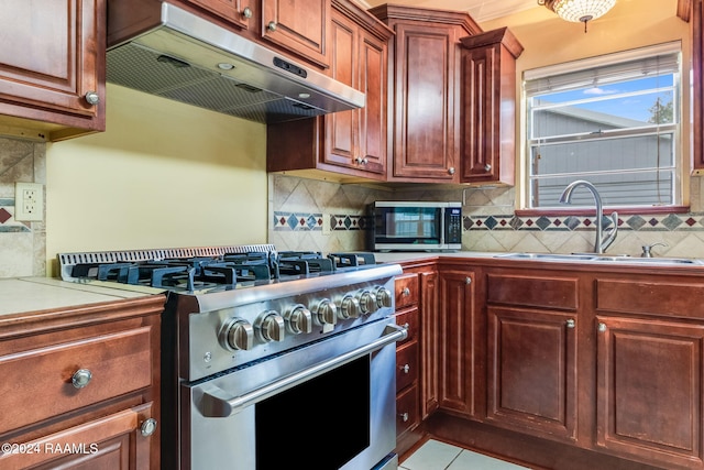 kitchen featuring stainless steel appliances, light tile patterned floors, sink, and tasteful backsplash