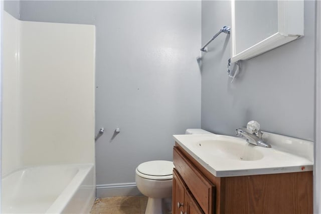 full bathroom featuring baseboards, vanity, and toilet