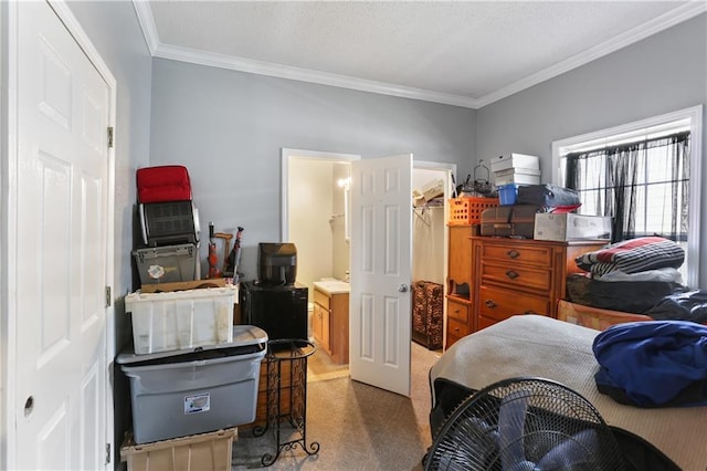 bedroom with ornamental molding, a closet, and a walk in closet