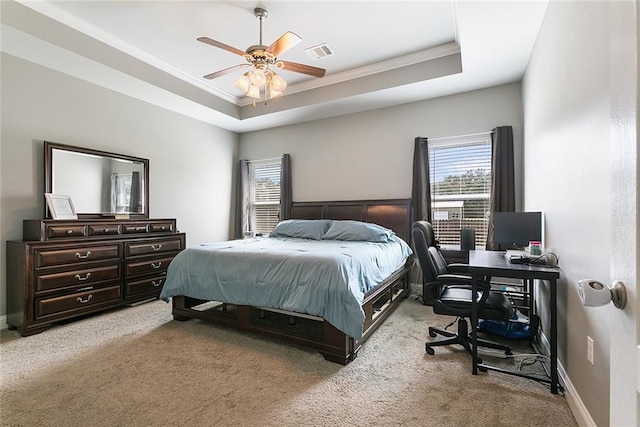 bedroom featuring baseboards, visible vents, a raised ceiling, and light colored carpet