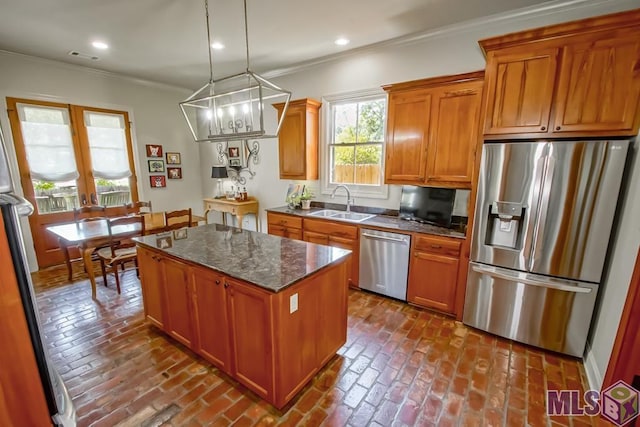 kitchen featuring appliances with stainless steel finishes, ornamental molding, brick floor, a sink, and recessed lighting