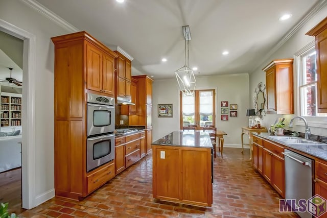 kitchen featuring a center island, brick floor, stainless steel appliances, a sink, and recessed lighting