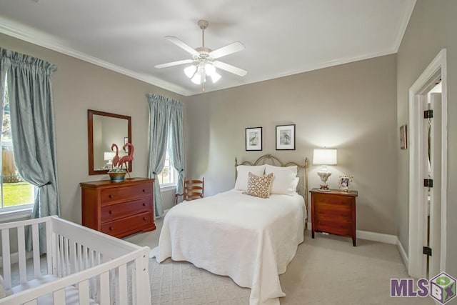 bedroom featuring a ceiling fan, light colored carpet, crown molding, and baseboards