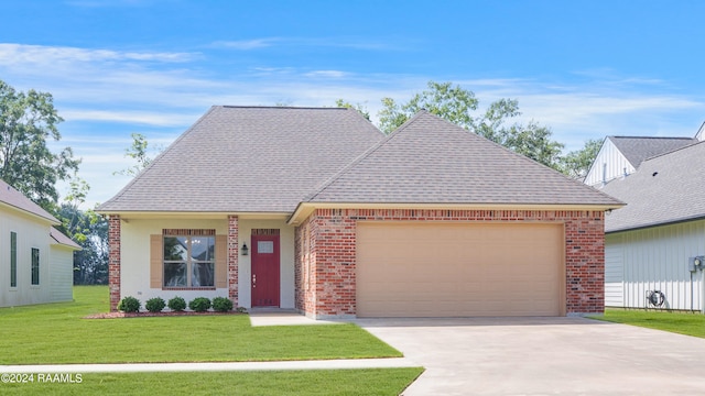 view of front of house with a garage and a front lawn