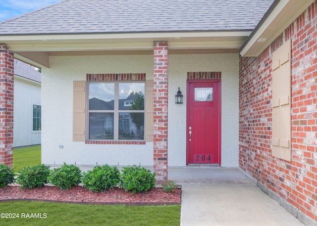 view of exterior entry with covered porch