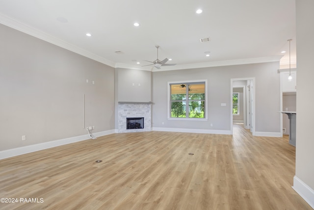 unfurnished living room featuring crown molding, ceiling fan, and light hardwood / wood-style flooring