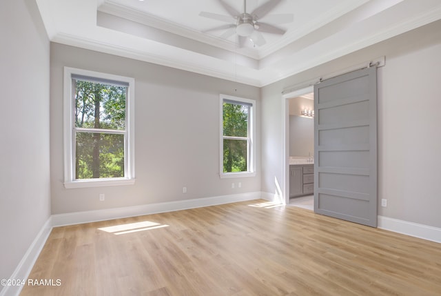 unfurnished bedroom with multiple windows, light wood-type flooring, and ornamental molding