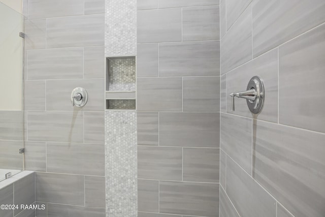 bathroom with tiled shower