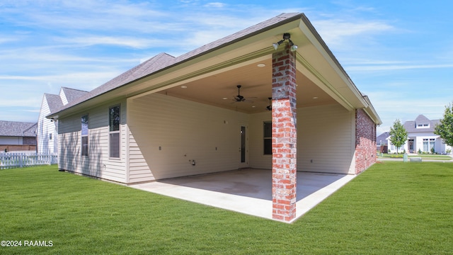 back of property with a yard and a carport