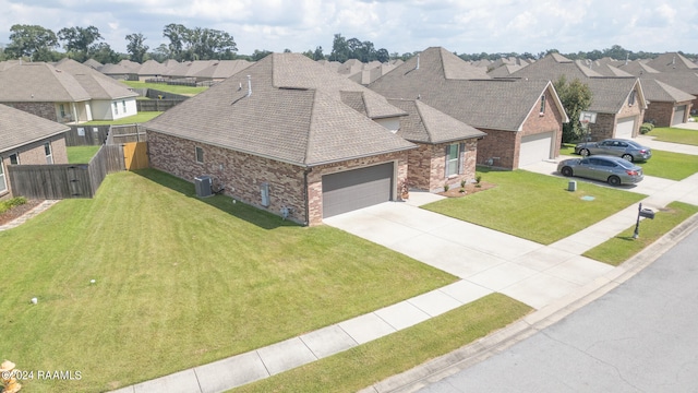 view of front of house with a front yard and central AC