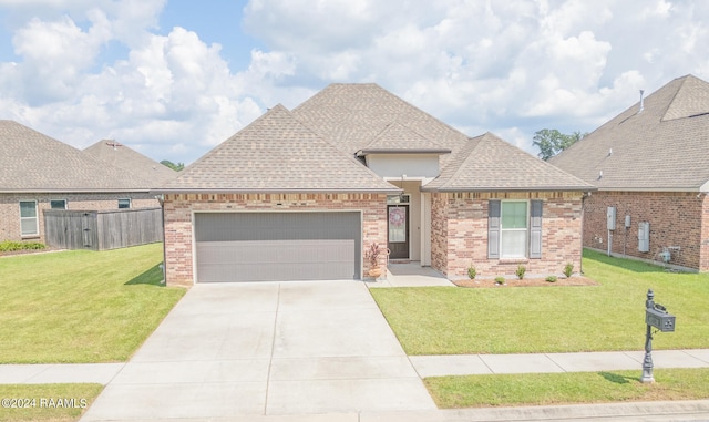 view of front of house featuring a front yard and a garage