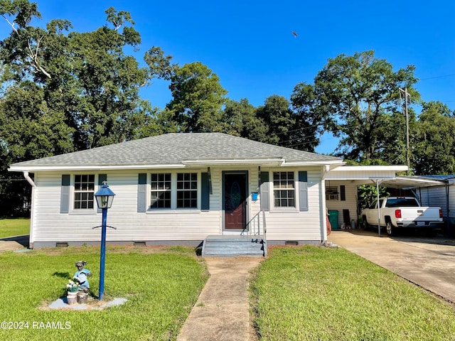 ranch-style home with a carport and a front yard