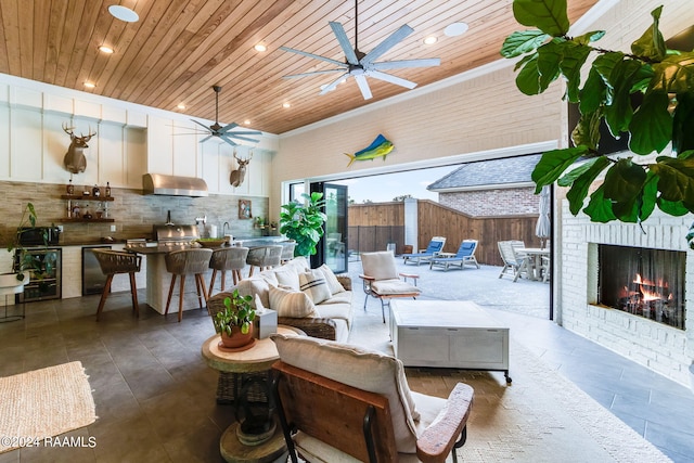 living room with wine cooler, ceiling fan, wooden ceiling, and a fireplace