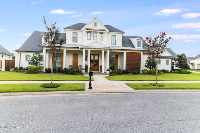 view of front of property with a front lawn and covered porch