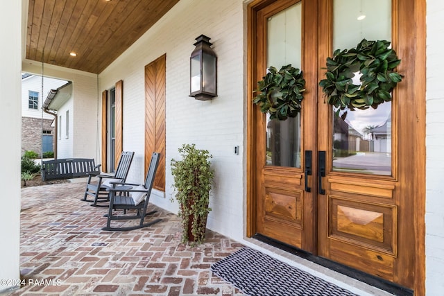 view of exterior entry with covered porch