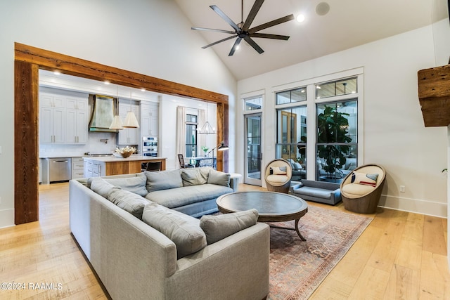 living room with high vaulted ceiling, ceiling fan, and light hardwood / wood-style flooring