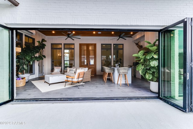 view of patio / terrace featuring ceiling fan, outdoor lounge area, french doors, and an AC wall unit