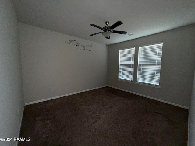 carpeted spare room with ceiling fan