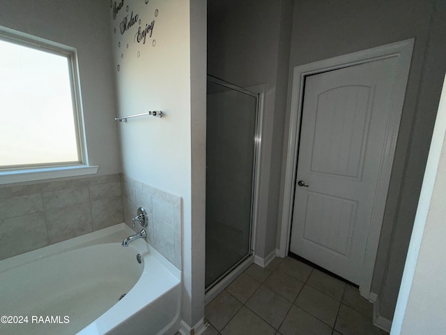 bathroom with independent shower and bath and tile patterned floors