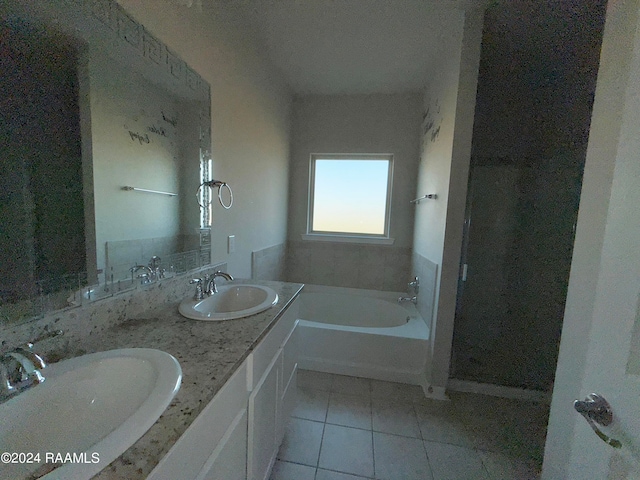 bathroom with vanity, a tub, and tile patterned floors