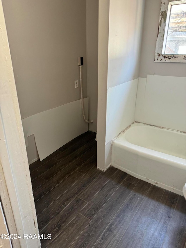 bathroom with a tub and hardwood / wood-style floors