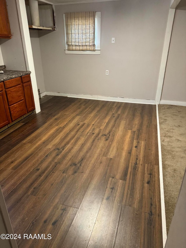 unfurnished bedroom with a closet and dark hardwood / wood-style flooring