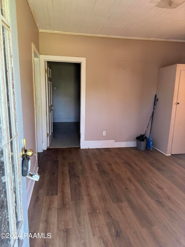 spare room with crown molding, dark hardwood / wood-style flooring, and wooden ceiling