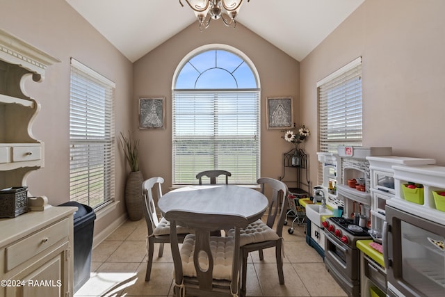 tiled dining room featuring a notable chandelier, vaulted ceiling, and a wealth of natural light