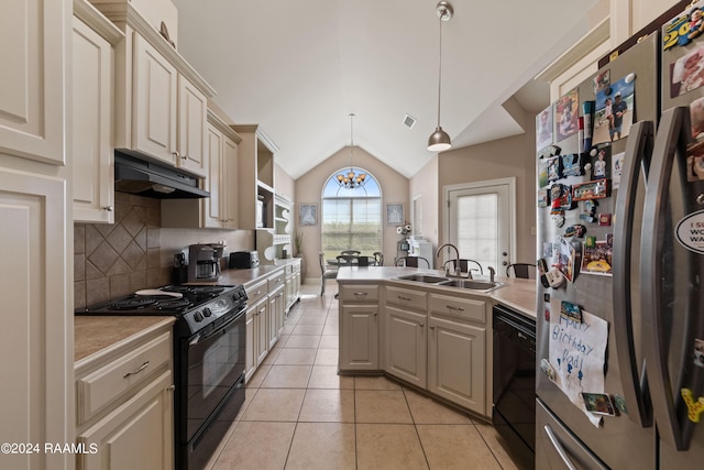 kitchen featuring light tile patterned flooring, sink, lofted ceiling, black appliances, and decorative light fixtures