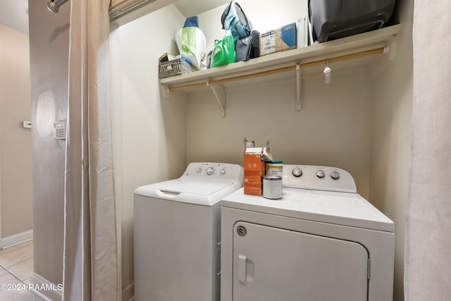 laundry room featuring light tile patterned flooring and washer and dryer