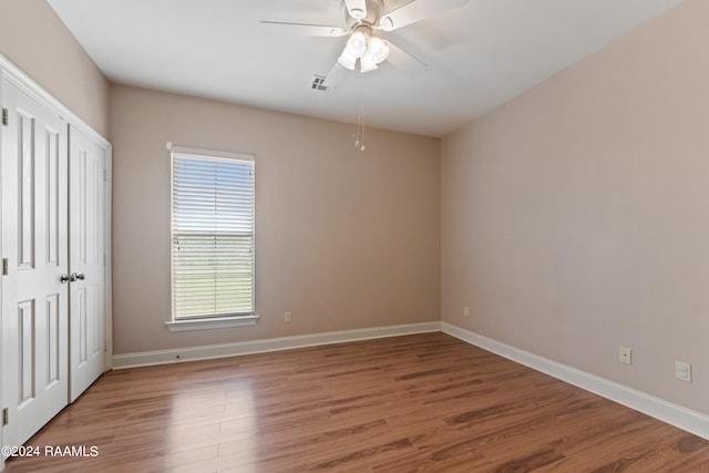 empty room with ceiling fan and wood-type flooring