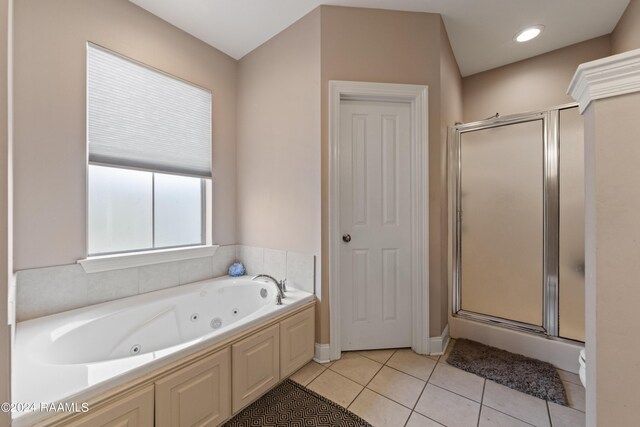 bathroom with tile patterned floors and separate shower and tub