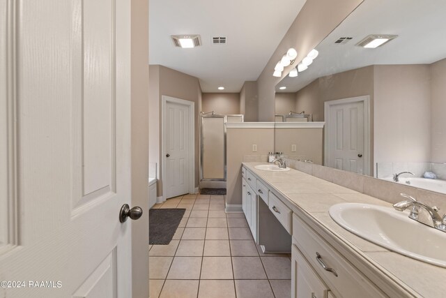 bathroom featuring vanity, separate shower and tub, and tile patterned floors