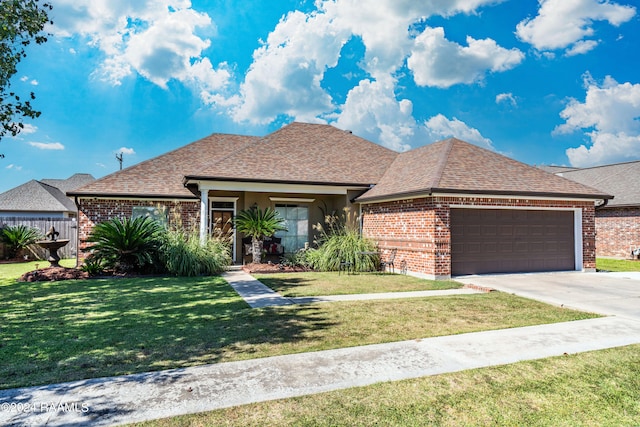 view of front of property with a front yard and a garage