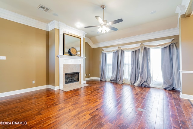 unfurnished living room with ceiling fan, ornamental molding, dark hardwood / wood-style flooring, and a fireplace