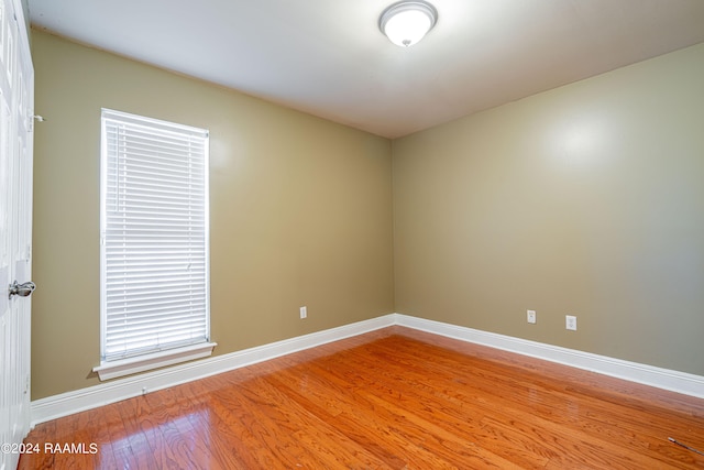 empty room with hardwood / wood-style flooring