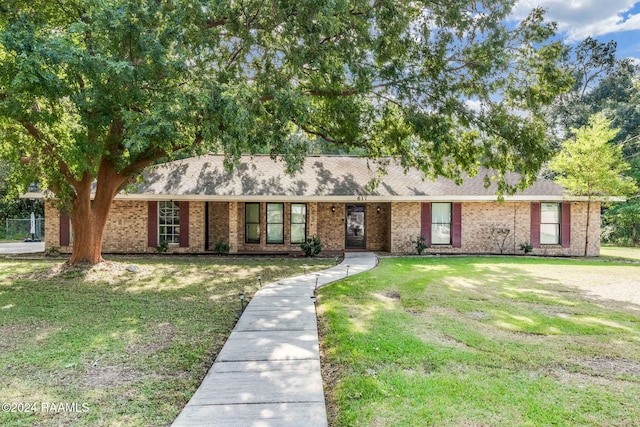 ranch-style house with a front lawn