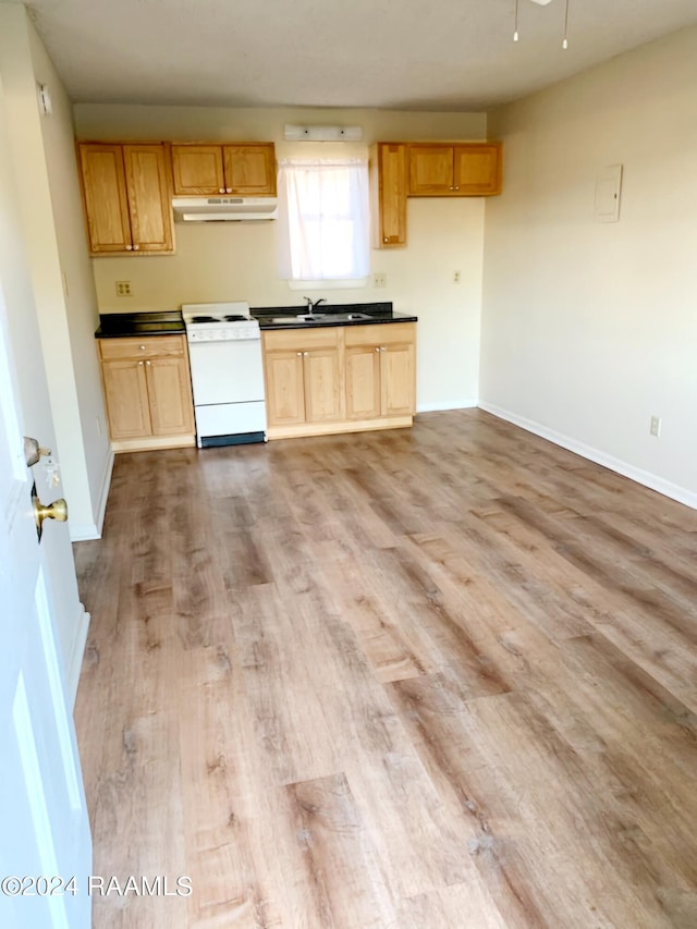 kitchen with sink, white range with electric stovetop, light brown cabinetry, and light wood-type flooring