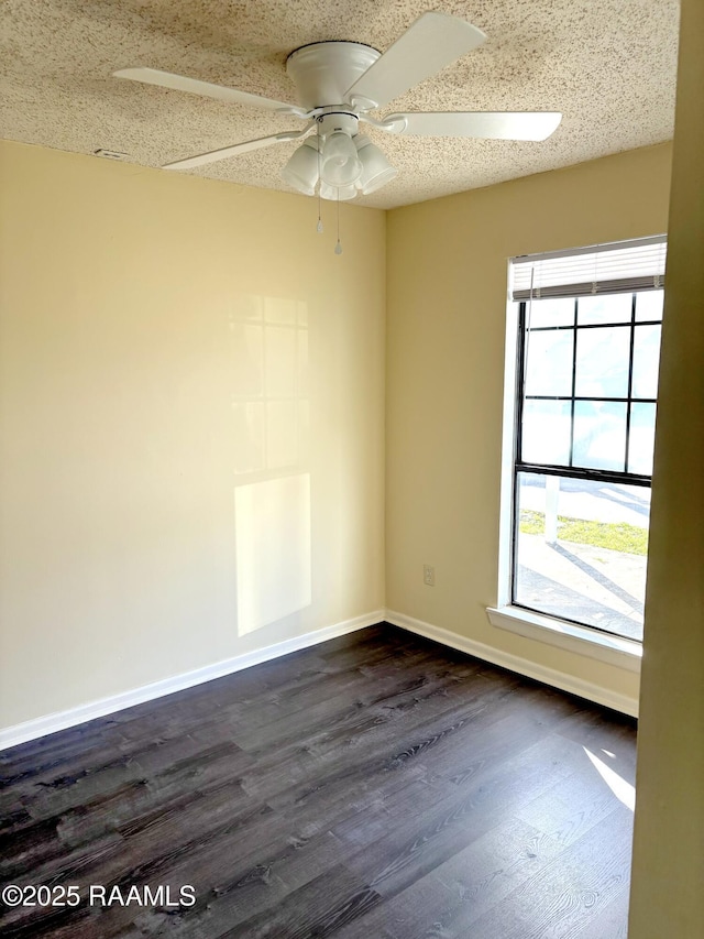 spare room with ceiling fan, dark hardwood / wood-style flooring, and a textured ceiling