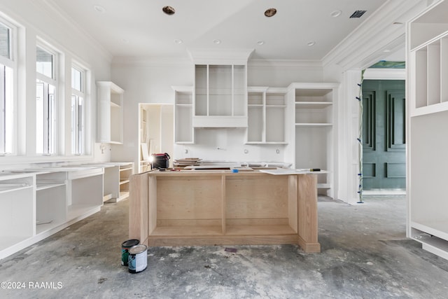 kitchen featuring light brown cabinets and ornamental molding