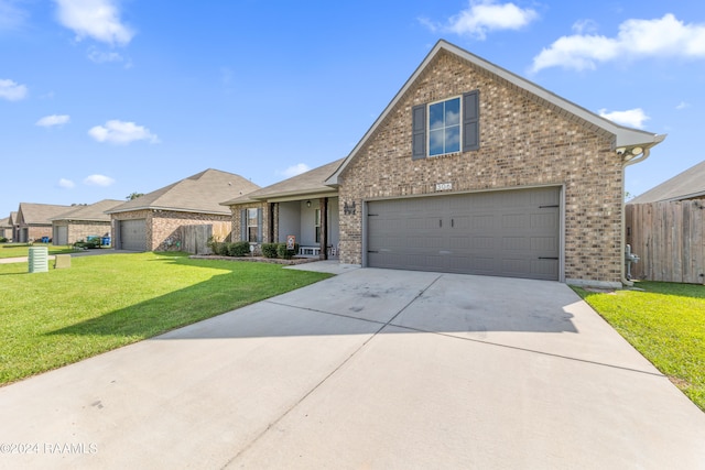 front facade featuring a garage and a front lawn