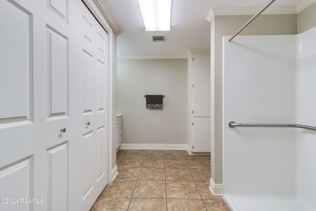 bathroom with a shower, ornamental molding, and tile patterned floors