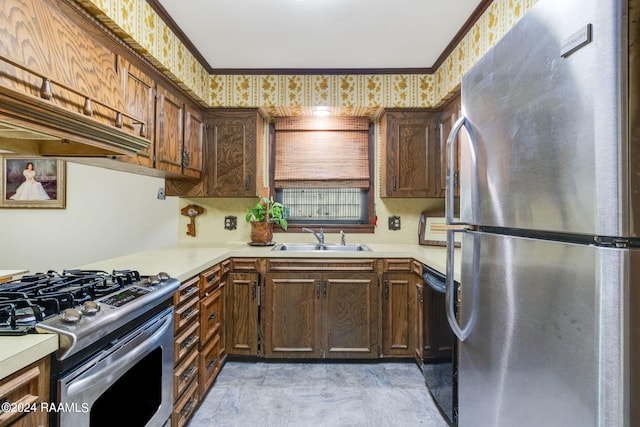 kitchen featuring ornamental molding, stainless steel appliances, and sink