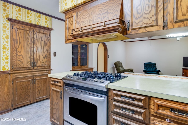 kitchen with ornamental molding and stainless steel range oven