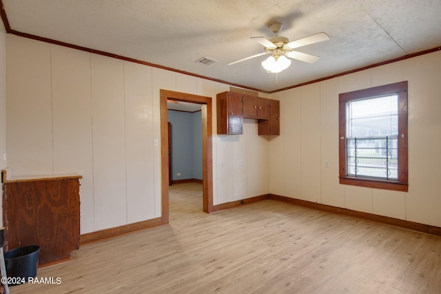 spare room featuring ceiling fan, a textured ceiling, crown molding, and light hardwood / wood-style floors