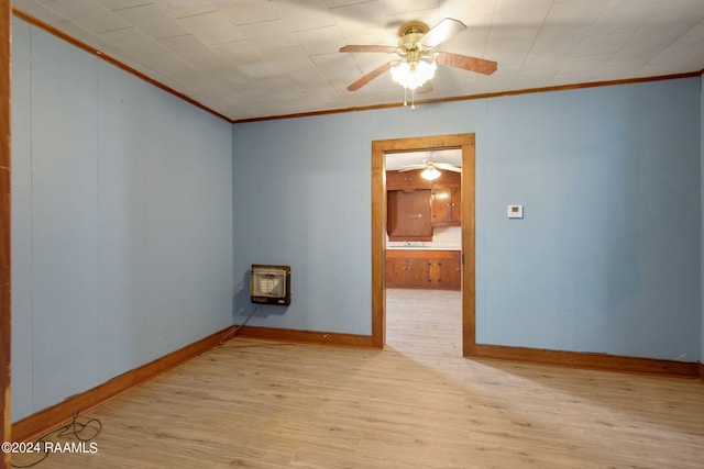 unfurnished room with heating unit, crown molding, ceiling fan, and light hardwood / wood-style flooring